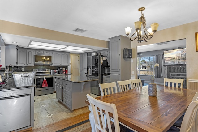 dining room featuring light wood-type flooring and an inviting chandelier