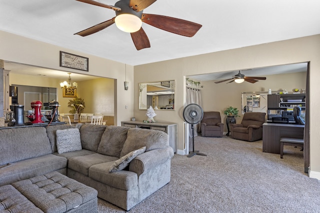 living room with light carpet and ceiling fan with notable chandelier