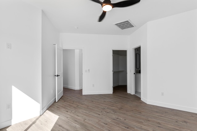 unfurnished bedroom with baseboards, visible vents, and wood finished floors