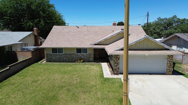 43861 W Elm Ave, Lancaster, CA 93534 - view of front of house featuring stone siding, an attached garage, driveway, and roof with shingles