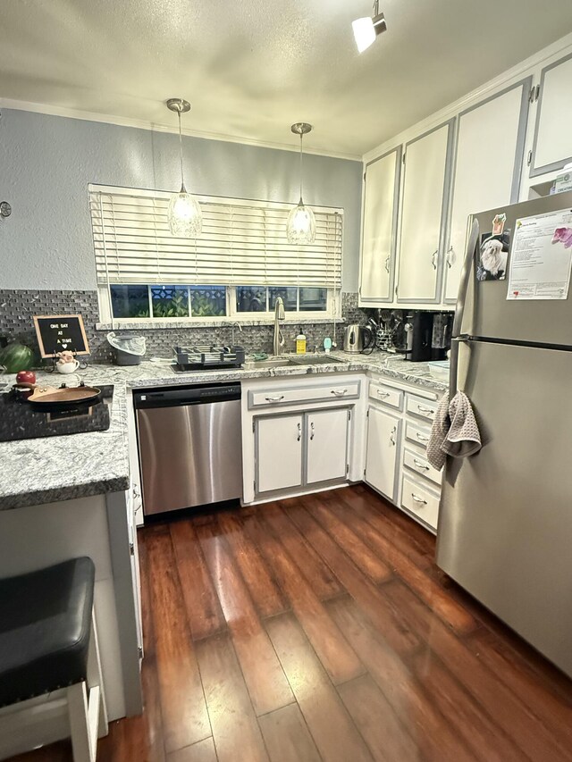 43861 W Elm Ave, Lancaster, CA 93534 - kitchen with freestanding refrigerator, stainless steel dishwasher, a sink, backsplash, and white cabinets