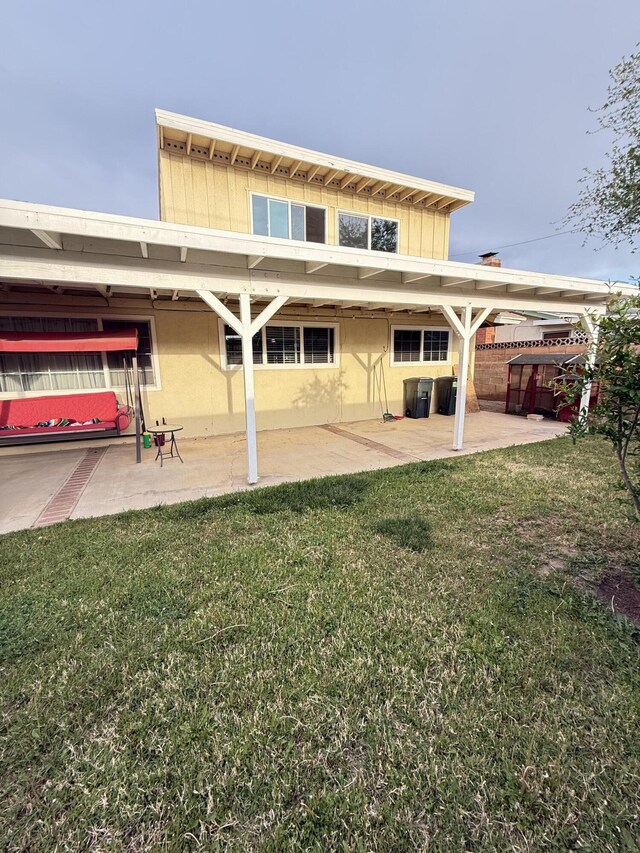 43861 W Elm Ave, Lancaster, CA 93534 - rear view of property with a patio, a yard, cooling unit, and stucco siding