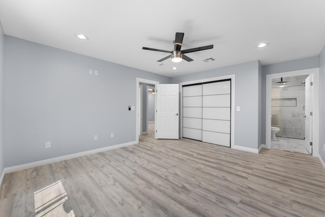 unfurnished bedroom featuring connected bathroom, ceiling fan, a closet, and light wood-type flooring