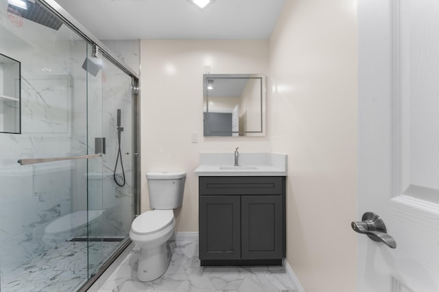 bathroom with vanity, toilet, and a shower with shower door