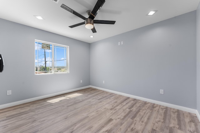 unfurnished room featuring light hardwood / wood-style flooring and ceiling fan