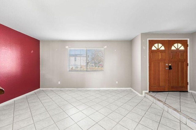 entrance foyer featuring light tile patterned floors and baseboards