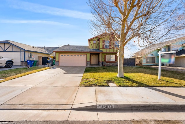 view of front of home featuring a garage, stone siding, driveway, stucco siding, and a front yard