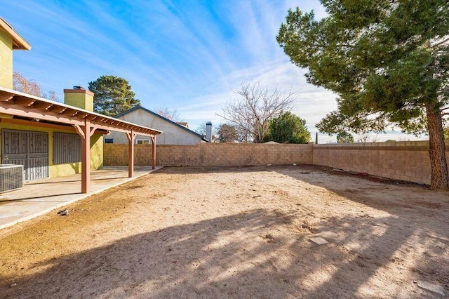 view of yard featuring central air condition unit, a patio area, and a fenced backyard