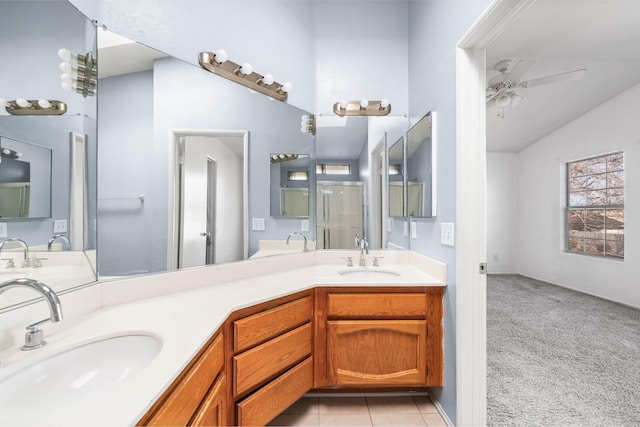 bathroom featuring lofted ceiling, double vanity, a sink, and tile patterned floors