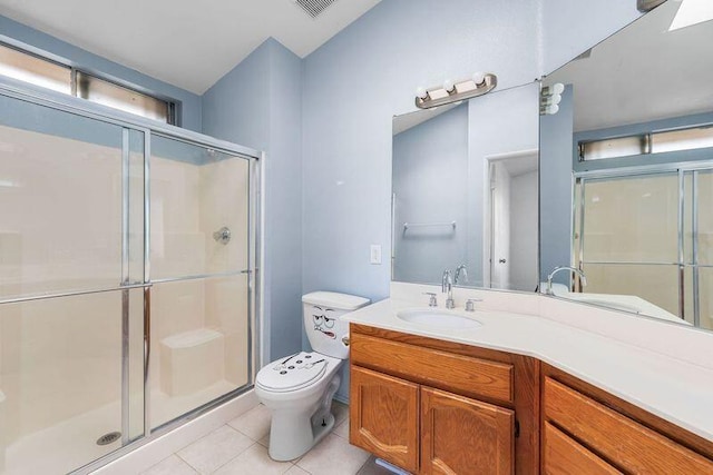 full bath with a stall shower, vanity, toilet, and tile patterned floors