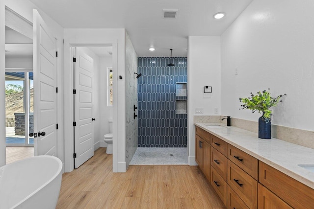 29181 Fawn Way, Tehachapi, CA 93561 - full bathroom with a tile shower, wood finished floors, a freestanding tub, toilet, and recessed lighting