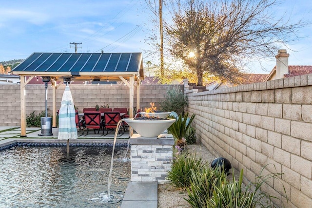 view of patio / terrace with an outdoor fire pit