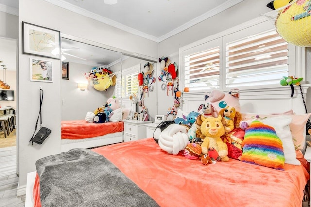 bedroom featuring ceiling fan, a closet, and ornamental molding