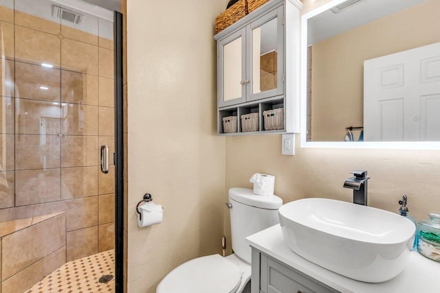 bathroom featuring vanity, toilet, and walk in shower