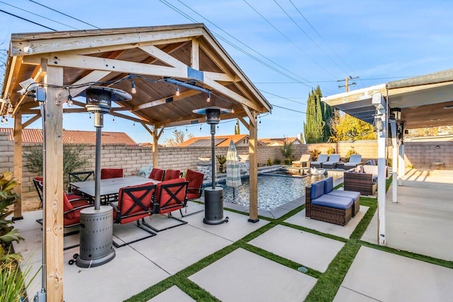 view of patio / terrace with outdoor lounge area, a gazebo, and a swimming pool