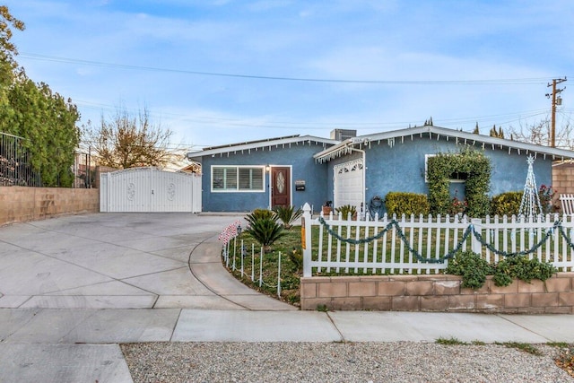 ranch-style house featuring central AC unit and a garage