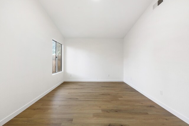 2203 Scott Ave, Palmdale, CA 93550 - empty room with visible vents, baseboards, and wood finished floors