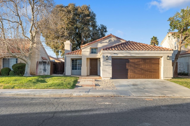 2203 Scott Ave, Palmdale, CA 93550 - mediterranean / spanish-style home with a garage, driveway, stucco siding, a tiled roof, and a front yard