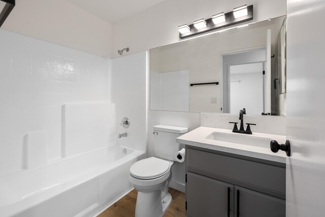 2203 Scott Ave, Palmdale, CA 93550 - bathroom with wood finished floors, vanity, toilet, and shower / bathtub combination