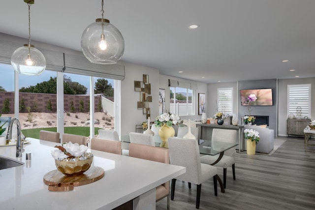 dining area featuring a fireplace, wood finished floors, and recessed lighting