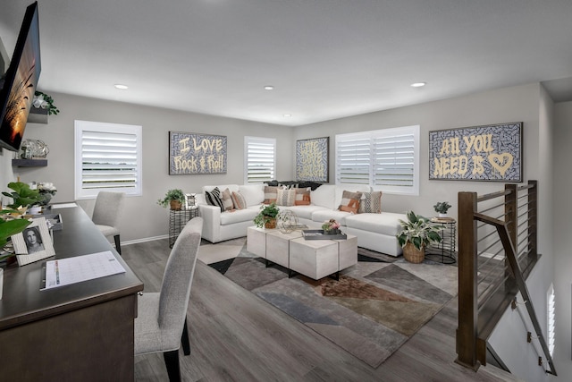 living room with recessed lighting, baseboards, and wood finished floors