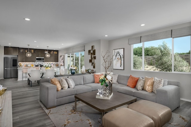 living area with recessed lighting and light wood-style flooring