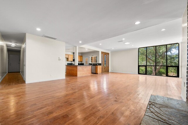 13113 Johnson Rd, Lake Hughes, CA 93532 - unfurnished living room with expansive windows and light hardwood / wood-style flooring