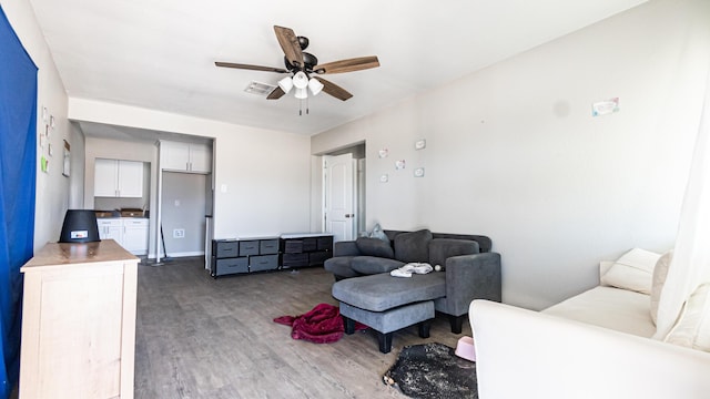 living room with wood finished floors and ceiling fan