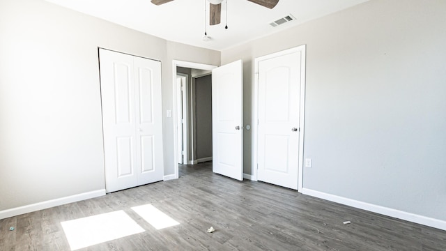 unfurnished bedroom with wood finished floors, baseboards, and a ceiling fan