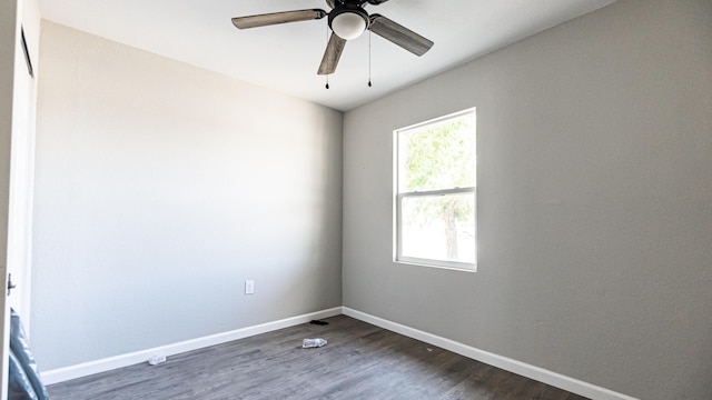 empty room with dark wood-type flooring, baseboards, and ceiling fan