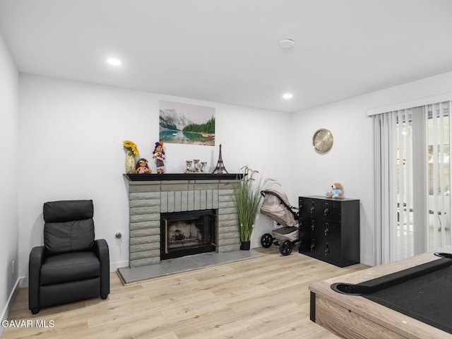 1324 Windermere Ct, Palmdale, CA 93551 - living area with wood finished floors, a fireplace, and recessed lighting