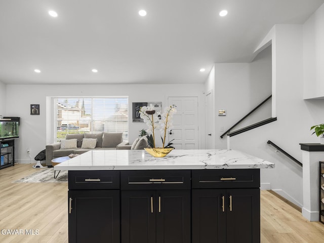 1324 Windermere Ct, Palmdale, CA 93551 - kitchen featuring dark cabinets, light wood finished floors, light stone countertops, open floor plan, and recessed lighting