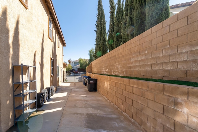 40947 Ridgegate Ln, Palmdale, CA 93551 - view of property exterior with fence, a patio area, and stucco siding