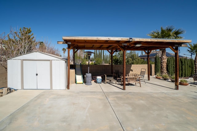 40947 Ridgegate Ln, Palmdale, CA 93551 - view of patio featuring an outbuilding, a shed, and fence