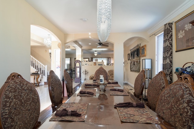 40947 Ridgegate Ln, Palmdale, CA 93551 - dining area with arched walkways, stairway, a ceiling fan, and baseboards