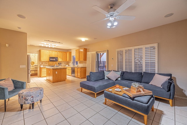 living room featuring light tile patterned floors and a ceiling fan