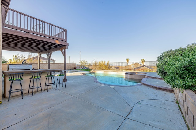 view of swimming pool with outdoor dry bar, a patio area, and a fenced backyard