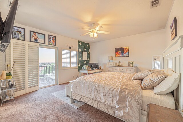 carpeted bedroom featuring access to exterior, visible vents, and a ceiling fan