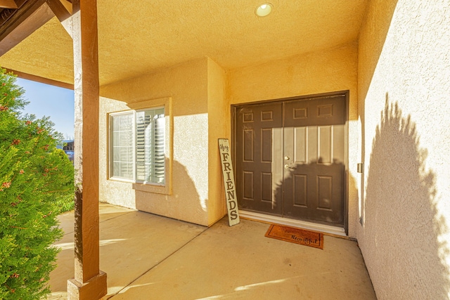 doorway to property with stucco siding