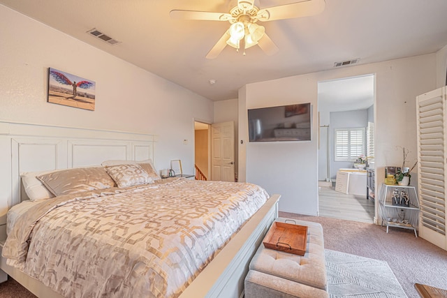 bedroom with a ceiling fan, light colored carpet, and visible vents