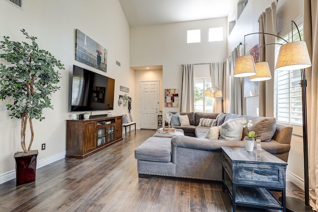 28097 Promontory Ln, Valencia, CA 91354 - living room with dark wood-type flooring, plenty of natural light, a high ceiling, and baseboards