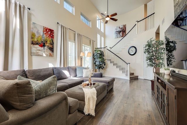 28097 Promontory Ln, Valencia, CA 91354 - living area with stairway, a towering ceiling, dark wood-style floors, a ceiling fan, and baseboards