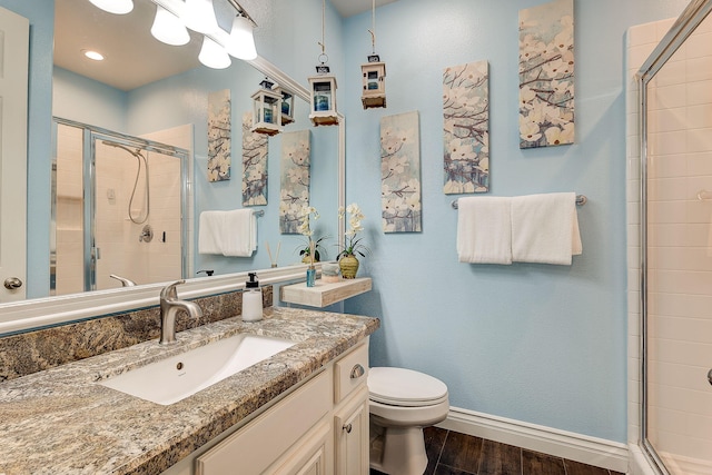 28097 Promontory Ln, Valencia, CA 91354 - full bathroom featuring a stall shower, baseboards, wood finished floors, toilet, and vanity