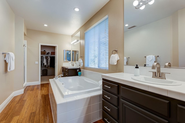 28097 Promontory Ln, Valencia, CA 91354 - full bathroom with a garden tub, wood finished floors, a shower stall, a spacious closet, and two vanities