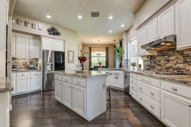 28097 Promontory Ln, Valencia, CA 91354 - kitchen featuring stainless steel appliances, under cabinet range hood, recessed lighting, a chandelier, and white cabinetry