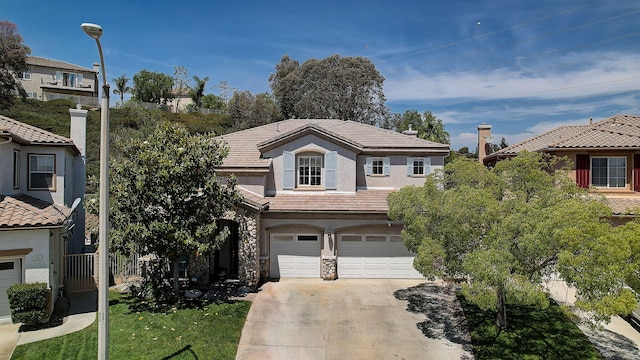 28097 Promontory Ln, Valencia, CA 91354 - view of front of property with concrete driveway, a tiled roof, a garage, stucco siding, and stone siding