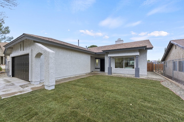 view of front of property featuring a garage and a front lawn