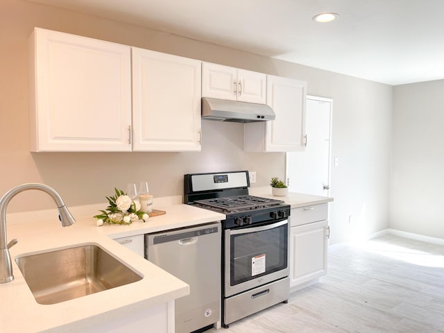 429 Peg St, Ridgecrest, CA 93555 - kitchen with appliances with stainless steel finishes, under cabinet range hood, light countertops, white cabinets, and recessed lighting