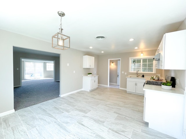 429 Peg St, Ridgecrest, CA 93555 - kitchen with light countertops, white cabinetry, range, under cabinet range hood, and recessed lighting