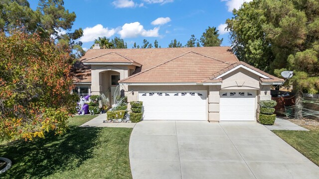 view of front of house featuring a front yard and a garage